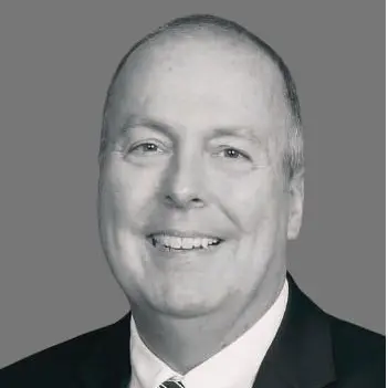 A black and white headshot of SSE's Senior Vice President & Chief Financial Officer, Jim Dobbins.